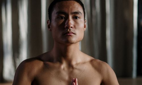 Person practicing a focused yoga balance pose.